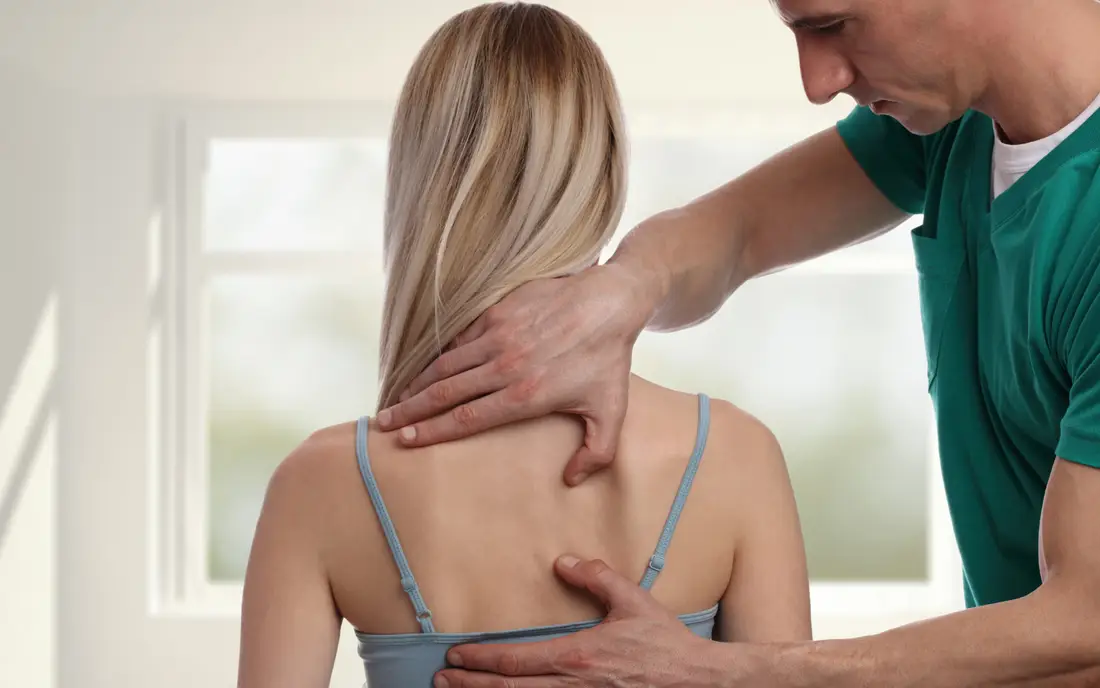 Woman receives chiropractic massage treatment.